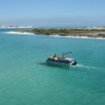 Destin boat rental traveling through crystal-clear waters
